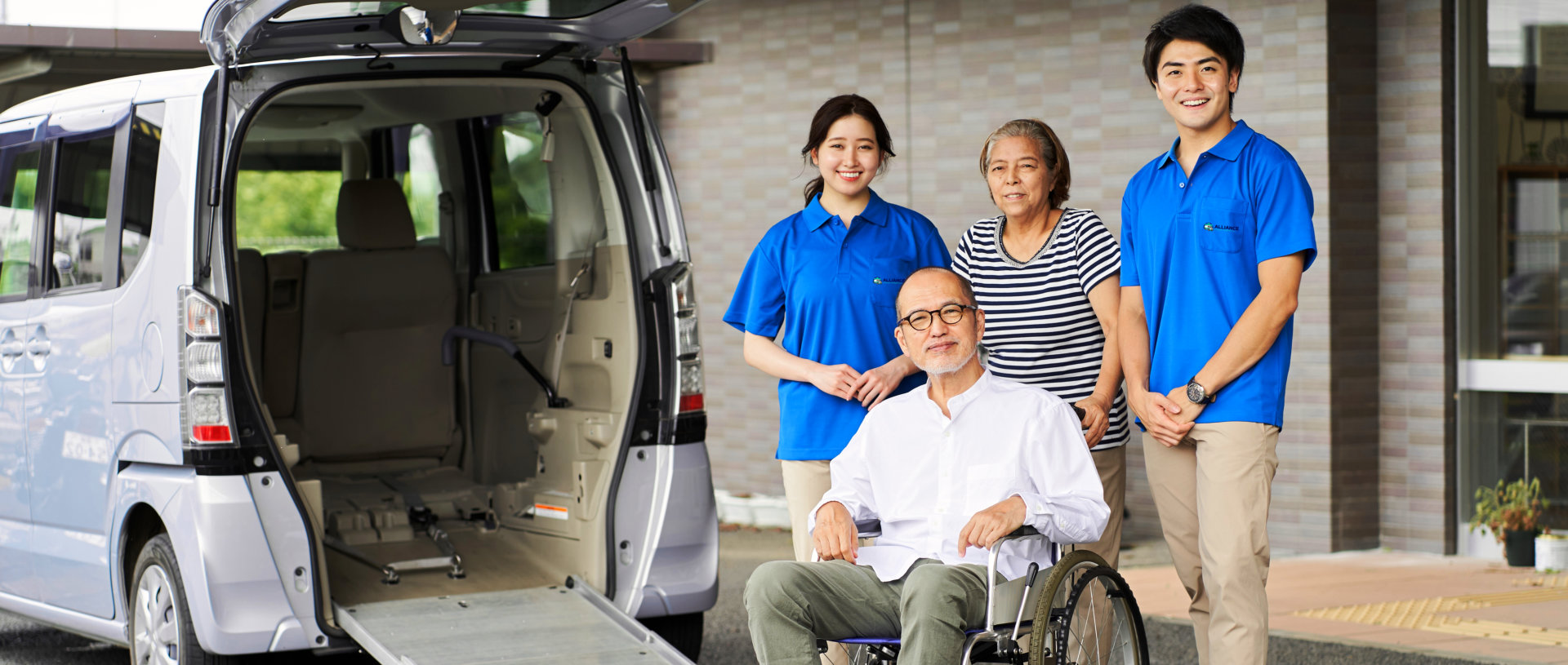 caretaker and elderly couple smiling