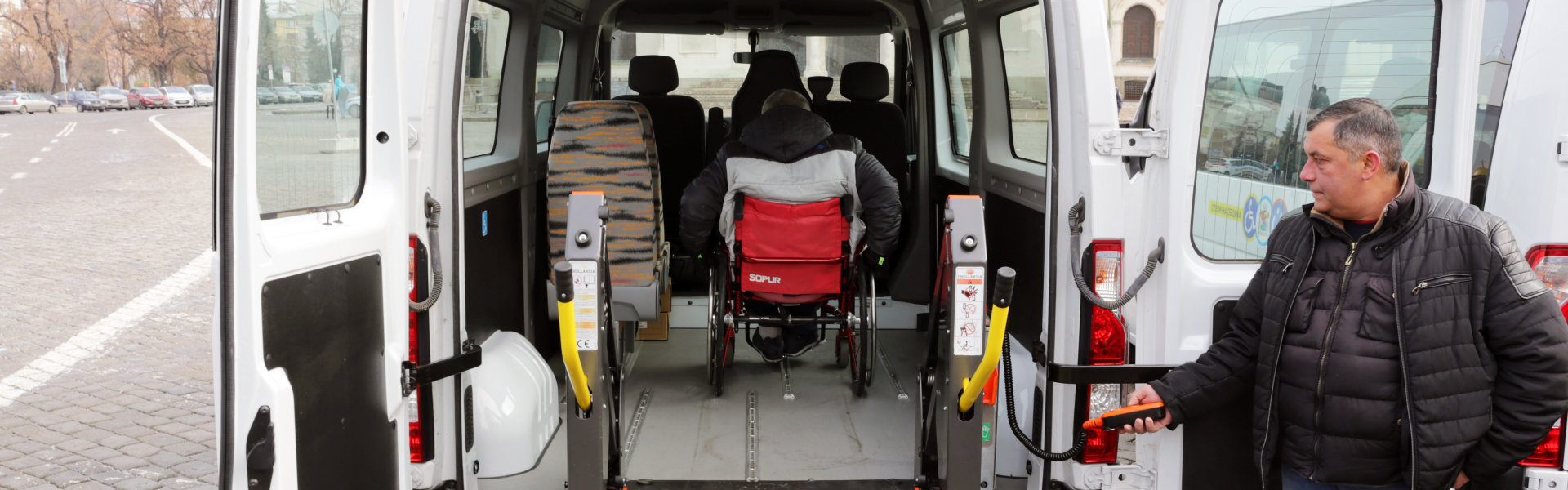 Driver assists a physically man in a wheelchair