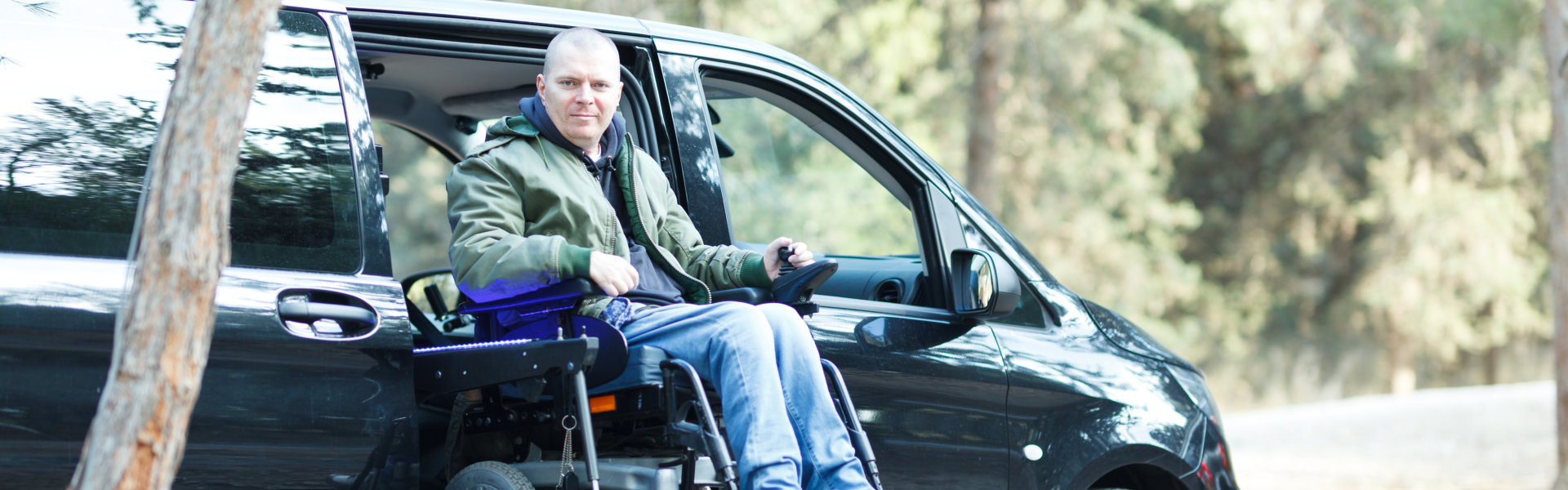 man on wheelchair standing on the car lift