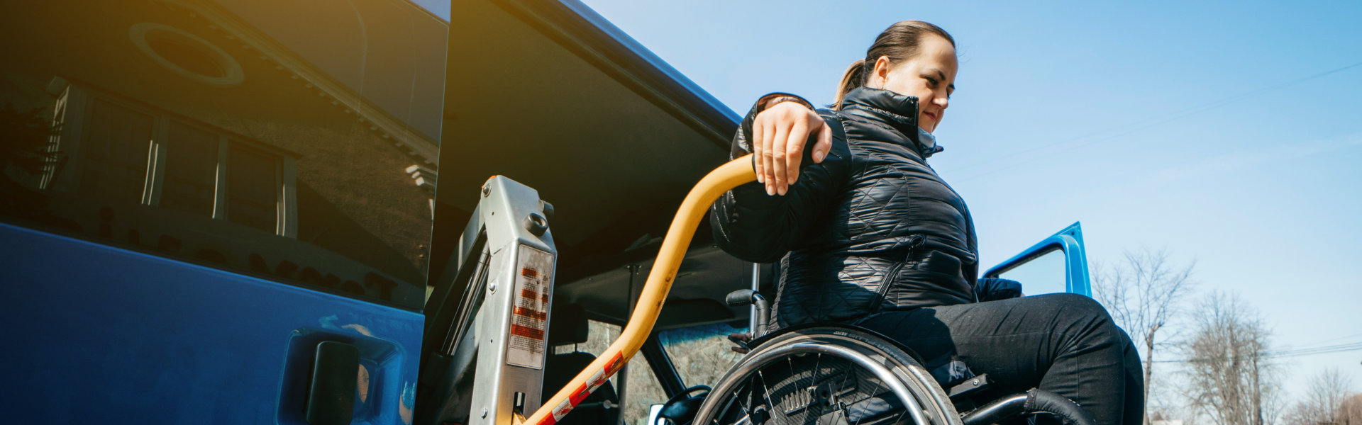 Handicap with a woman in a wheelchair on a lift